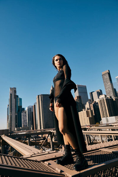 A young woman dances on a bridge in New York City.