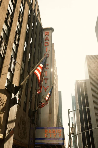 NUEVA YORK, EE.UU. - 13 de octubre de 2022: banderas de EE.UU. en el edificio del Radio City music hall en Manhattan - foto de stock