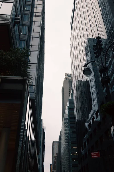 Vista de ángulo bajo de edificios modernos de gran altura en la calle urbana de la ciudad de Nueva York - foto de stock