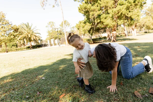 Menina da criança rindo perto da mãe enquanto brincam juntos no parque de Miami — Fotografia de Stock
