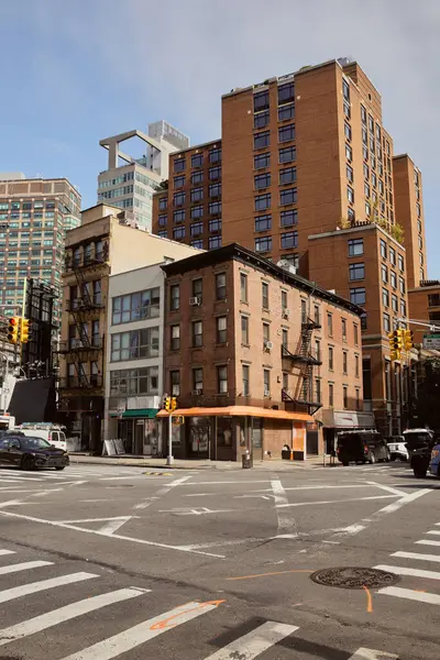 Différents bâtiments de style près de carrefour avec des voitures en mouvement dans la ville de New York, architecture urbaine — Photo de stock