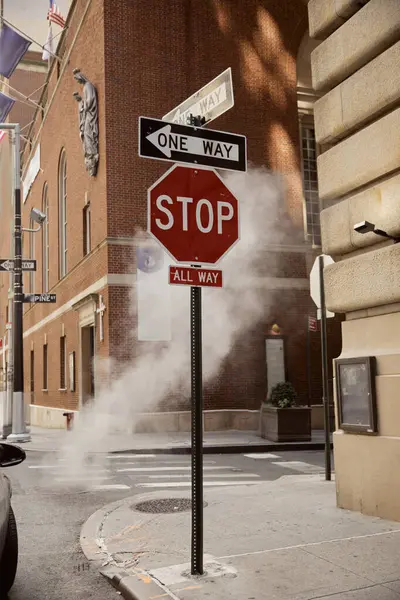 Signalisation routière à proximité de la vapeur et des bâtiments anciens dans le centre-ville de New York, environnement métropole — Photo de stock