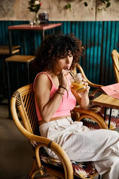 A woman in stylish attire enjoys a refreshing drink while on a European trip. — Stock Photo