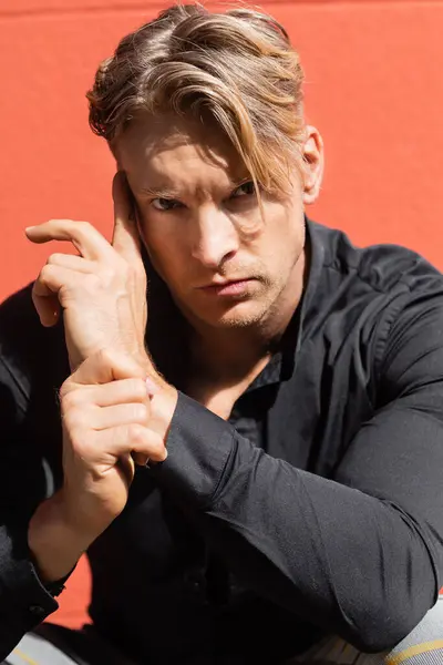 A handsome blonde man poses in stylish attire on a street in Orlando, Florida. — Stock Photo
