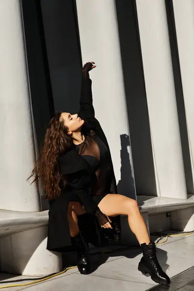 A young woman in black dances expressively on the streets of New York City. — Stock Photo