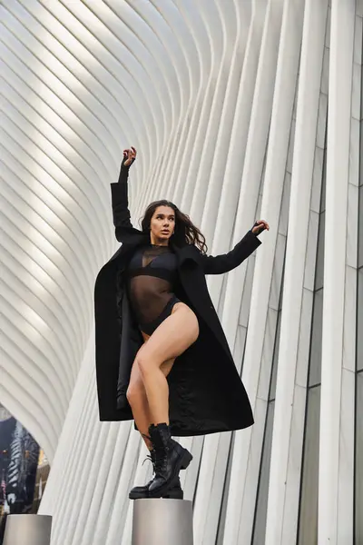 Young woman gracefully dances in NYC streets, framed by modern architecture. — Stock Photo