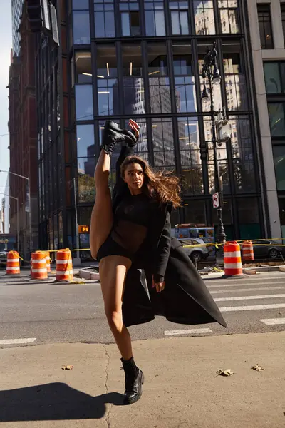 A young woman dances on a city street in New York City. — Stock Photo