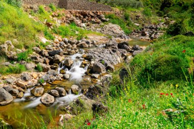 long exposure mountain river flowing between rocky shores 