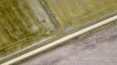 Kırsal kesimde kara yol Fransa 'da kışın insansız hava aracı tarafından görülen tarlalarla çevrili.