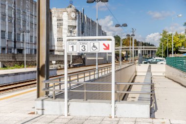 Vila Nova de Famalicao, Braga, Portugal - October 22, 2020: exterior architectural detail and its platforms of the Famalicao railway station on an autumn day clipart