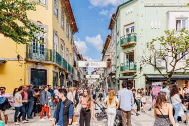 Braga, Portugal - May 26, 2024: Street atmosphere in the historic city center during the Braga Romana event with visitors walking around on a spring day clipart