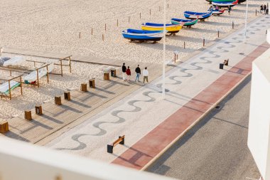 Nazare, Portugal - May 28, 2024: Aerial view of Nazare town and Praia da Nazare beach on a spring day with sunny weather clipart