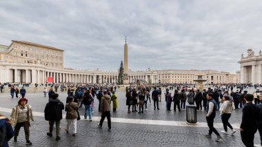 Vatican City, Vatican - December 29, 2023: Street atmosphere in San Pietro Square (Saint Peter's Square) where tourists are walking on a winter day in bad weather clipart