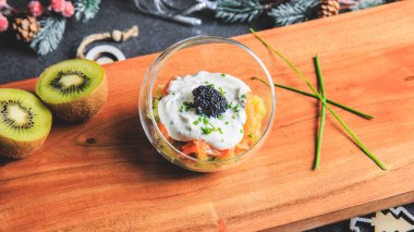 Kiwi salmon cream cheese and lumpfish roe verrine in studio with Christmas decoration clipart