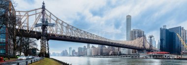 Manhattan, New York, USA - February 16, 2024: Ed Koch Queensboro Bridge and surroundings on a gray winter day clipart