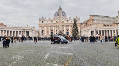 Vatican City, Vatican - December 29, 2023: Street atmosphere in San Pietro Square (Saint Peter's Square) where tourists are walking on a winter day in bad weather clipart