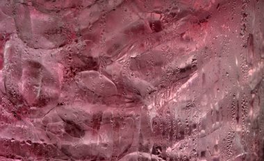 Pink soft drink with ice cube