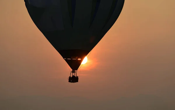 A balloon silhouette with sunset in background