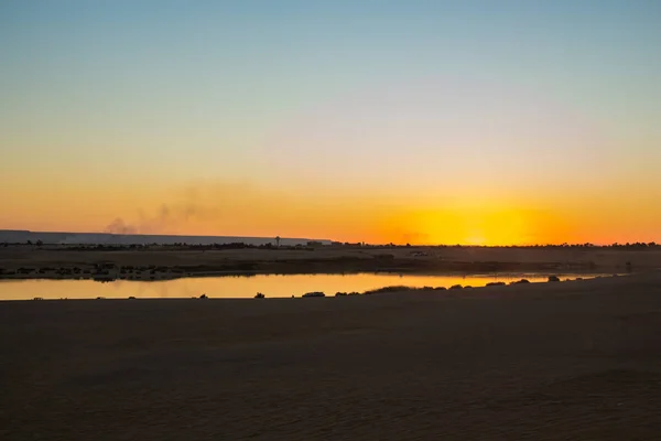 Sun set on magic lake surrounded by desert at Fayoum, sun set  shot