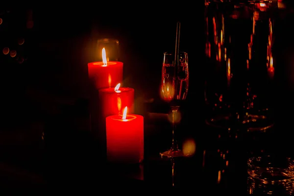 Red romantic candle light in a black background, shot is selective focus with shallow depth of field