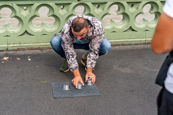 Stock image London, UK - july 30 2022: Thieves playing shell game on Westminster Bridge