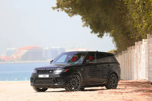 stock image black Luxury Full Option Range Rover Velar Parked showing beautiful Dubai Skyline in background