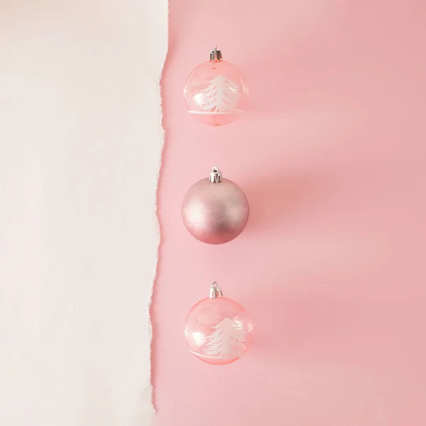Christmas creative layout with pink bauble decoration on pastel pink background. New Year celebration creative idea. Retro aesthetic minimal concept, copy space.