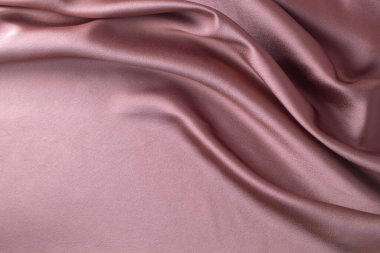 Pürüzsüz pembe ipek ya da saten lüks kumaş dokusu soyut bir arkaplan olarak kullanılabilir. Lüks arkaplan tasarımı