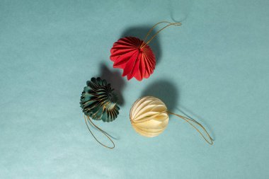 Noel süslemeleri, pastel mavisi bir arka fona yerleştirilmiş bal peteği şeklinde kağıttan yapılmıştır. Dekorasyon için tasarlanmış süsler.