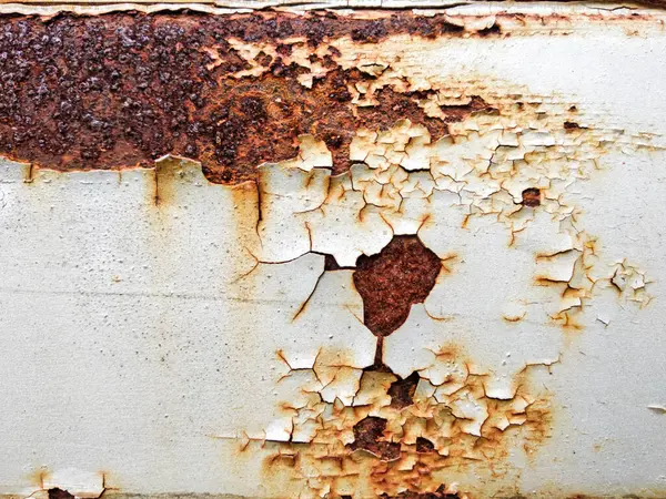 Paslı metal yüzeyi ve kabuğu soyulmuş boya tabakası.