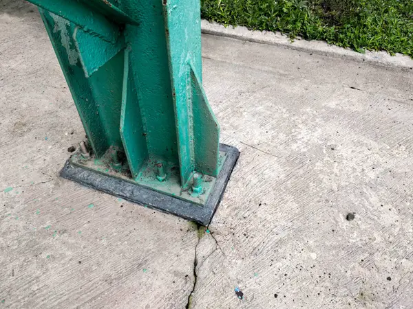 a green metal post of an industrial building