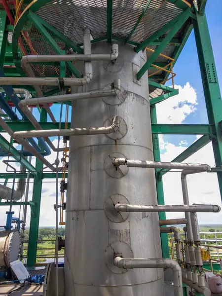 distillation column tower with some pipe connected to every tray in it