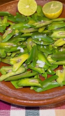 İnga edulis tohumları, limon ve tuzla birlikte kil bir tabakta servis edilen egzotik meyveler. Genel olarak: guama, guaba, pacae veya pacay
