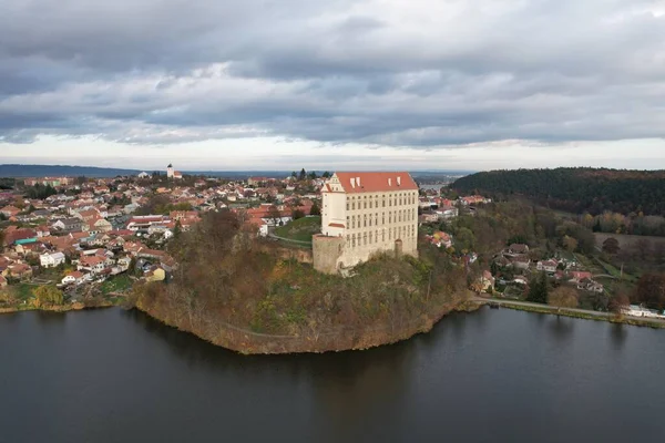 Aerial view of picturesque Czech town Plumlov with castle, Olomouc Region,reflected on the surface of Plumlov Lake, designed by Charles Eusebius of Liechtenstein. Tourist spot, Czech republic