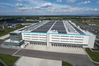 KOJETIN,Czech republic-September 24 2022:Brand new huge Amazon Warehouse distribution center exterior. Aerial view of massive sort and distribute logistics center,Europe,Kojetin Czech solar powerplant clipart