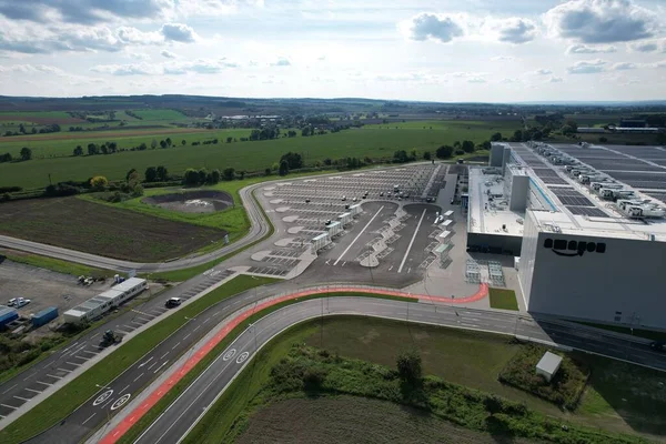 stock image KOJETIN,Czech republic-September 24 2022:Brand new huge Amazon Warehouse distribution center exterior. Aerial view of massive sort and distribute logistics center,Europe,Kojetin Czech solar powerplant