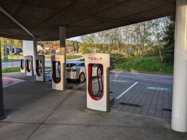 Humpolec, CZECH REPUBLIC - 16 Mayıs 2023: Tesla şarj istasyonları tüm AB 'de elektrikli otomobil sahiplerini barındırmak için mevcuttur. Tesla süperşarj istasyonu Prag ve Brno arasında D1 otoyolu üzerindedir.