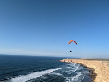 Morocco seaside beaches and cliffs around Agadir area,Africa, paragliding over scenic sea side landscape clipart