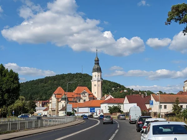 stock image Bilina,Czech republic-July 9 2023:Bilina historical city center with fountains and cobble stone square, churches and castle above the old town