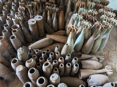 unexploded land mines and cluster bombs remains picked up all around Cambodia after war,now set in Museum of landmines in Siem Reap Cambodia, huge amount of ammunition is still laying in countryside clipart