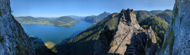 Drachenwand Klettersteig with suspension bridge and beautiful panorama view on Mondsee lake,Austria,Europe, via ferratas and panoramas seen from climbing the road clipart