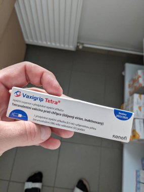 Prag, Çek Cumhuriyeti - 14 Ekim 2023: Eczane kavramı-Vaxigrip tetra aşı paketi bir buzdolabı eczacısının elinin önünde. Bu aşı sizi veya çocuğunuzu gribe karşı korumaya yardımcı olur (grip).)