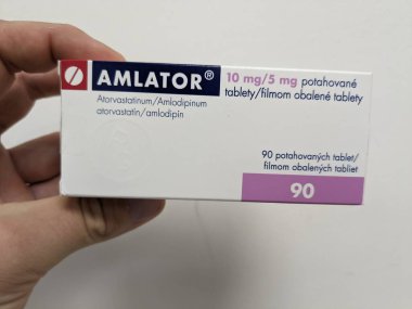 Prague, Czech Republic - July 10 2024: AMLATOR box of medication with AMLODIPINE and ATORVASTATIN active substances by ZENTIVA, used for treatment of hypertension and hyperlipidemia. clipart