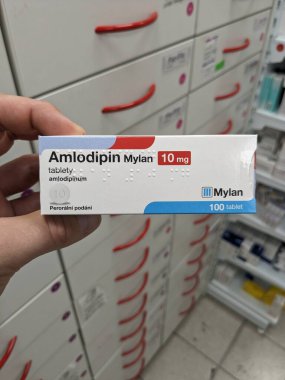 Prague, Czech Republic - July 10 2024: AMLODIPIN MYLAN box of medication with AMLODIPINE active substance by MYLAN, used for treatment of hypertension and cardiovascular health. clipart