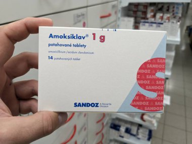 Prague,Czech republic-June 17 2024: Amoksiklav box of medication with Amoxicillin and Clavulanic acid active substances by Lek Pharmaceuticals, used for treatment of bacterial infections clipart