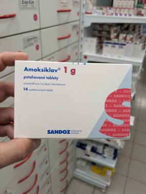 Prague,Czech republic-June 17 2024: Amoksiklav box of medication with Amoxicillin and Clavulanic acid active substances by Lek Pharmaceuticals, used for treatment of bacterial infections clipart