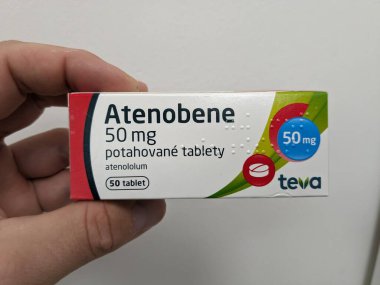 Prague, Czech Republic - July 10 2024: ATENOBENE box of medication with ATENOLOL active substance by TEVA, used for treatment of hypertension and cardiovascular health. clipart