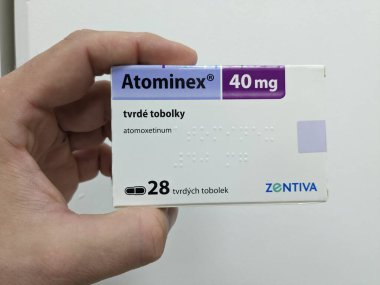 Prague, Czech Republic - July 10 2024: ATOMINEX box of medication with ATOMOXETINE active substance by INTAS, used for treatment of ADHD. clipart