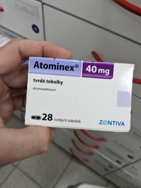 Prague, Czech Republic - July 10 2024: ATOMINEX box of medication with ATOMOXETINE active substance by INTAS, used for treatment of ADHD. clipart