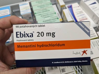 Prague, Czech Republic - July 10 2024: EBIXA box of medication with MEMANTINE active substance by LUNDBECK, used for treatment of Alzheimer's disease and dementia. clipart